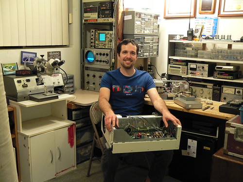 Me in my electronics room.  I'm holding the beginnings of a cryogenic receiver project.